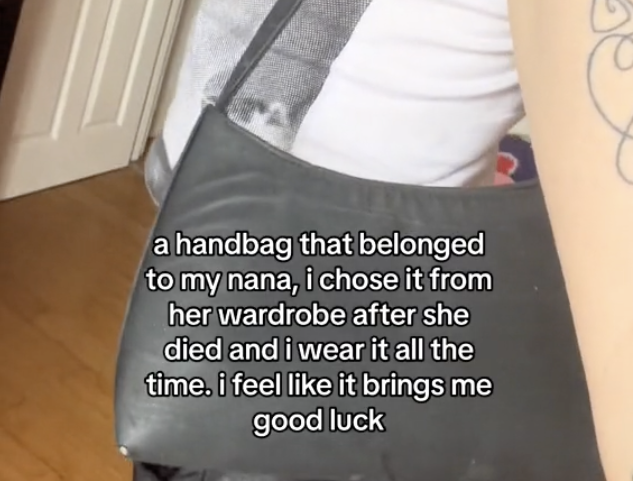 woman wearing old handbag